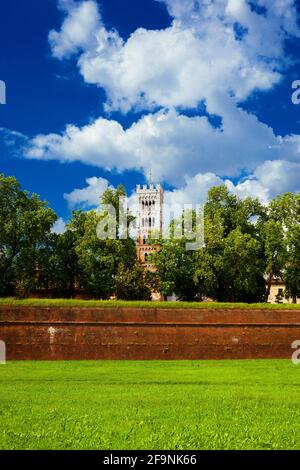 Spring in Lucca. Ancient walls park with cathedral belfry and green grass Stock Photo