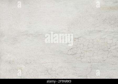 Texture background of white plastered wall with peeling paint close-up Stock Photo