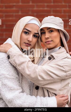 Affective young women wearing hijab smiling and looking at camera. Stock Photo