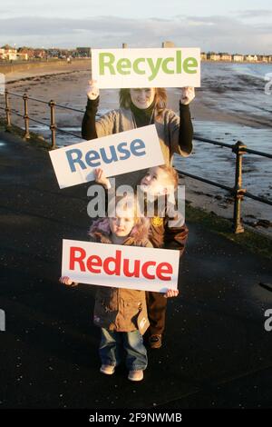 Reduce Reuse Recycle. Mother with two children promoting campaign Stock ...