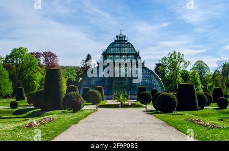 Palmenhaus pavilion greenhouse in garden of Schloss Schonbrunn palace, Vienna, Austria. Schonbrunn Palace is former imperial summer residence located Stock Photo