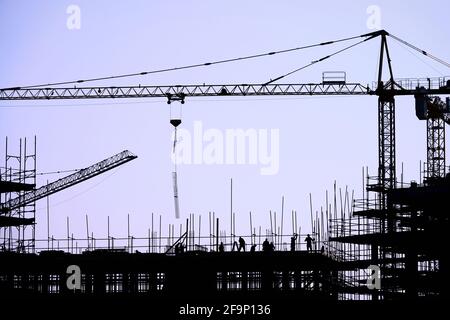 The group of workers working at a construction site. Stock Photo