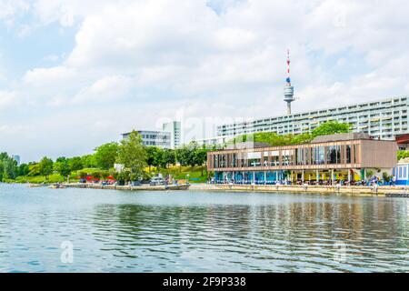 View of restaurants on the shore of donau river near VIC and Donauturm in Vienna, Austria. Stock Photo