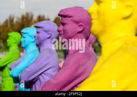 Group of painted copies of a male person looking at the Azadi Tower in Tehran, Iran. Stock Photo