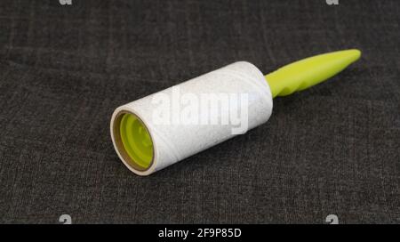 reusable sticky roller for cleaning clothes. Designed to remove dust, wool, lint from any type of fabric Stock Photo