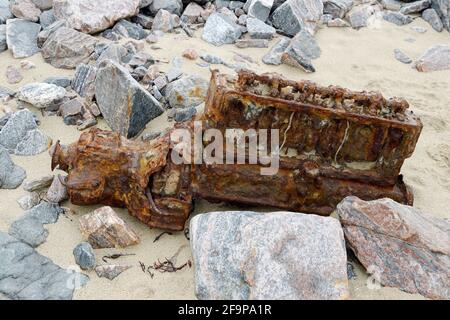 Old marine boat engine block rusting on Cliff Beach, Valtos aka Bhaltos in western Lewis, Outer Hebrides, Scotland Stock Photo