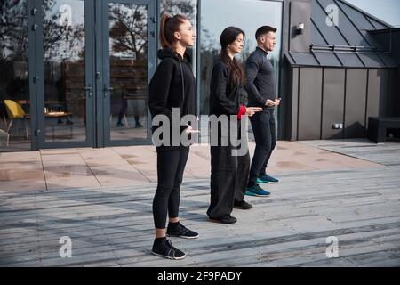 Relaxation qigong exercise in group of three Stock Photo