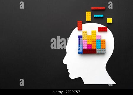 Papercut silhouette of human head with colorful constructor pieces Stock Photo