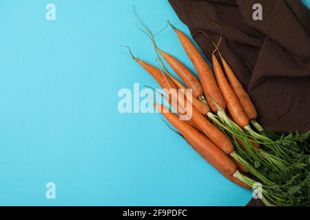 Kitchen towel with carrot on blue background Stock Photo