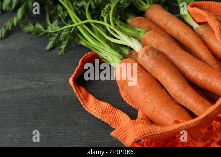 String bag with carrot on dark wooden background Stock Photo
