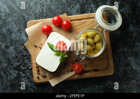 Concept of tasty food with feta cheese on black smokey background Stock Photo