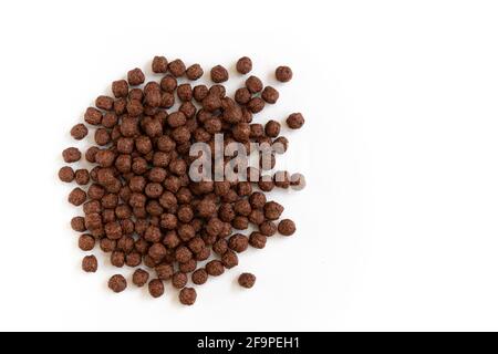 crunchy chocolate cereal balls isolated on white background, dry breakfast chocolate flavored balls, top view Stock Photo