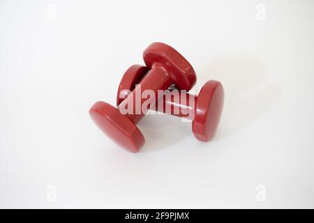 Pair of red dumbbells isolated on white background Stock Photo