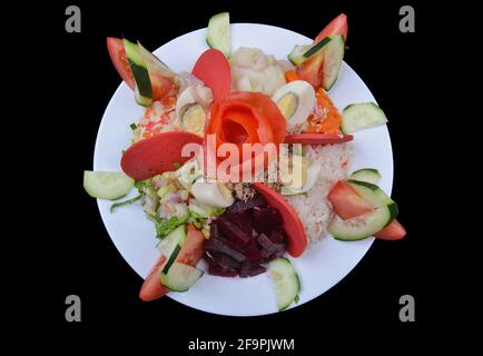 Moroccan salad with green rice and boiled eggs. Street restaurant concept. Black background Stock Photo