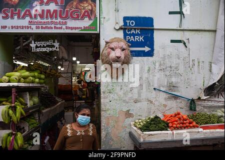 10.03.2021, Singapore, , Singapore - A woman wearing a Corona mouth mask outside a grocery store in the Little India neighborhood. 0SL210310D017CAROEX Stock Photo