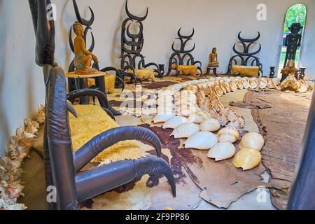 CHIANG RAI, THAILAND - MAY 11, 2019: Interior of the Solitude Stupa, with wooden sculptures, giant seashells, and chairs, made of wood and animal horn Stock Photo