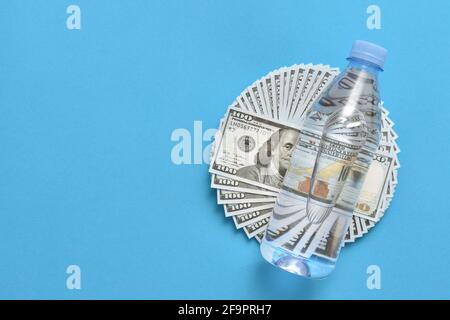 Plastic bottle lies on dollars Stock Photo
