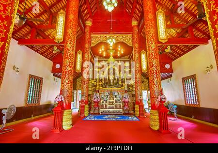 CHIANG RAI, THAILAND - MAY 11, 2019: The ornate interior of Wat Phra Kaew Temple main building with ornate columns, carvings and famous Phra Jao Lan T Stock Photo