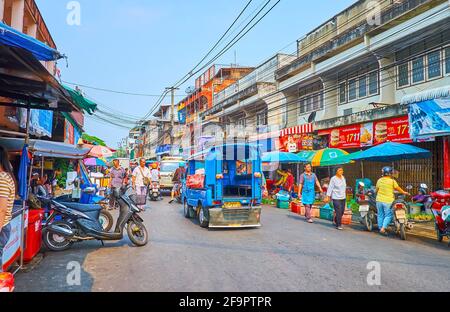 CHIANG RAI, THAILAND - MAY 11, 2019: The Uttarakit street is occupied with stalls and shops of day food market, on May 11 in Chiang Rai