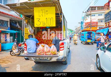 CHIANG RAI, THAILAND - MAY 11, 2019: The farmers sells the fresh rambutans from the truck in Uttarakit street of the Central Day Market, on May 11 in Stock Photo