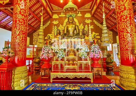 CHIANG RAI, THAILAND - MAY 11, 2019: The altar of Wat Phra Kaew Temple with medieval bronze Phra Jao Lan Thong Buddha Image, on May 11 in Chiang Rai Stock Photo