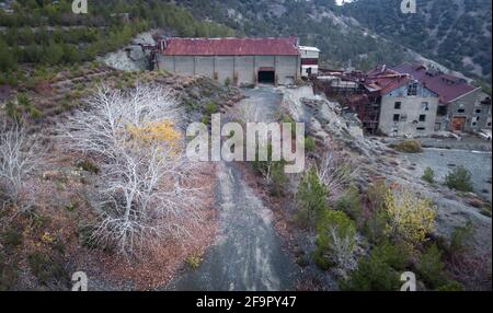 Abandoned factory buildings of former asbestos mine and colorful autumn landscape of Amiantos, Cyprus. Aerial view Stock Photo