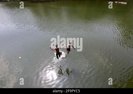 Dhaka, Bangladesh - April 20, 2021: It is summer in Bangladesh. Mischief in the water of Dhanmondi Lake in Dhaka for a little relief to the street chi Stock Photo