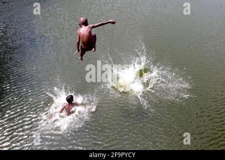 Dhaka, Bangladesh - April 20, 2021: It is summer in Bangladesh. Mischief in the water of Dhanmondi Lake in Dhaka for a little relief to the street chi Stock Photo