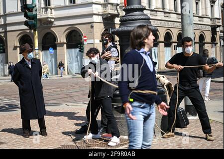 Milan, Italy. 20th Apr 2021. A man looks at performers during during a flashmob in front of Teatro alla Scala theatre in Milan Italy on April 20, 2021 to raise awareness on the conditions of entertainment business workers due to the pandemic Credit: Piero Cruciatti/Alamy Live News Stock Photo