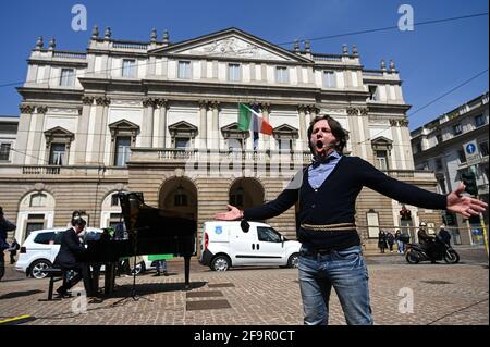 Milan, Italy. 20th Apr 2021. Opera singer Vitaly Kovalchuk performs during a flashmob in front of Teatro alla Scala theatre in Milan Italy on April 20, 2021 to raise awareness on the conditions of entertainment business workers due to the pandemic Credit: Piero Cruciatti/Alamy Live News Stock Photo
