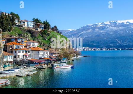 small houses are spread over a cliff near path leading to the saint johan at kaneo church in macedonian town ohrid. Stock Photo