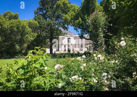 Historical Rhone Homestead Manor house from 1795 in cape dutch architecture style at Boschendal farm near Franschhoek, South Africa, against blue sky Stock Photo