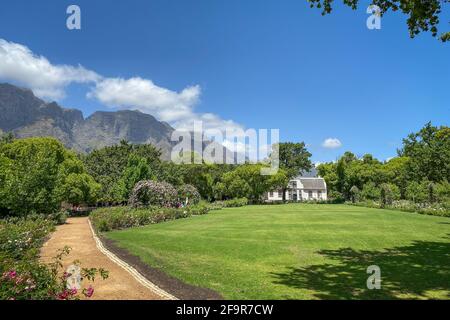 Historic Rhone Homestead Manor House from 1795 at Boschendal Winery near Franschhoek, South Africa with Hottentots Holland Mountains in the background Stock Photo