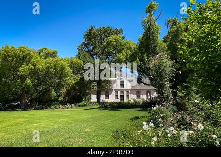 Historic Rhone Homestead Manor House from 1795 at Boschendal Winery near Franschhoek, South Africa with Hottentots Holland Mountains in the background Stock Photo