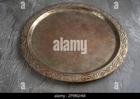 Old retro metal tray on a black stone background. Top view. Free copy space. Stock Photo