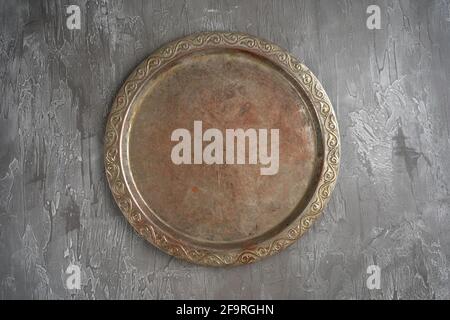 Old retro metal tray on a black stone background. Top view. Free copy space. Stock Photo