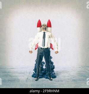 businessman with rockets on his back. concept of success and determination. Stock Photo