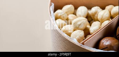 hazelnut in wooden box with cells for different nuts vegetarian food for healthy protein nutrition close-up, nobody. Stock Photo