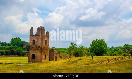 via appia used to be important trade route for antique merchants in ancient rome, nowadays leads thourgh fields among ancient gates, ruins and modern Stock Photo