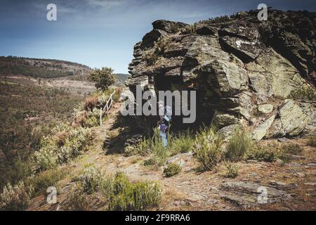 Man with backpack and cap exploring in the mountain Stock Photo