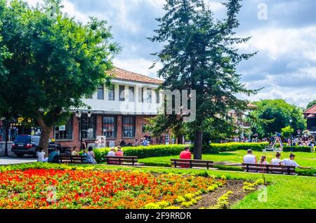 People are strolling around famous church in nesebar - The Christ Pantocrator - UNESCO World Heritage Site. Stock Photo