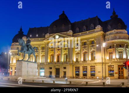 night view of the old Central University Library In Bucharest located on 'Calea Victoriei' Avenue near Constitution Square. Stock Photo