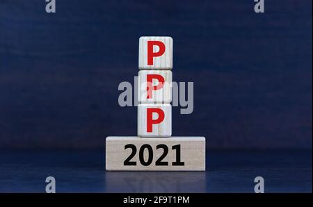 PPP, paycheck protection program 2021 symbol. Concept words PPP, paycheck protection program 2021 on wooden blocks on a beautiful grey background. Bus Stock Photo