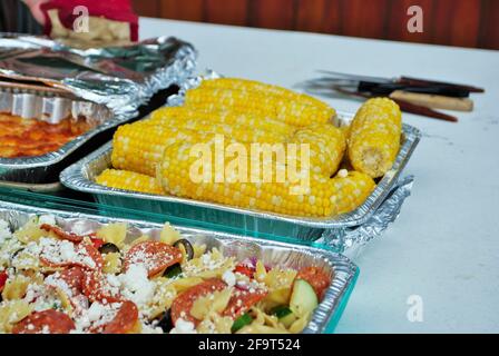 large assortment of dishes on the food table at a picnic Stock Photo