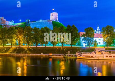 Aerial view of the illuminated Gediminas Tower and modern skyscrapers ...