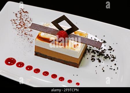 triple layered vanilla and chocolate mousse cake dessert Stock Photo