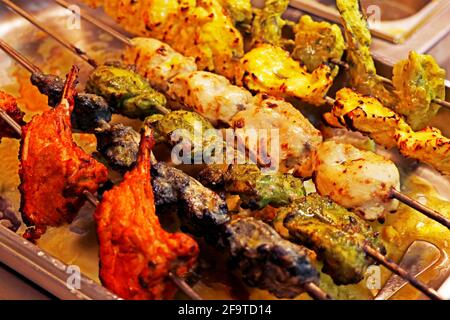 multi coloured and flavoured indian tandoori kebabs or tikka in a skewer, authentic cuisine Stock Photo