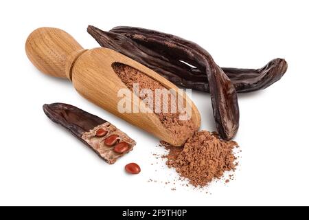 Carob pod and powder in wooden scoop isolated on white background with clipping path and full depth of field. Stock Photo