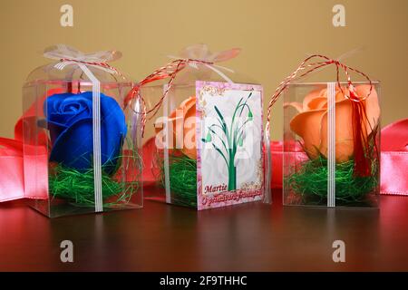 Artificial roses in plastic box. Romanian martisor. Stock Photo