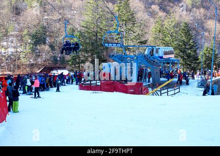 Slanic Moldova, Bacau, Romania - February 21, 2021: Lots of people waiting for the chairlift to the Nemira ski slope in Slanic Moldova Stock Photo